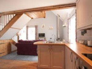 a kitchen and living room with an attic at Little Rigg Cottage in Pickering