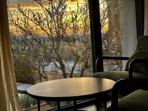 een tafel voor een raam met uitzicht bij Domaine de Quintalone in Cintegabelle