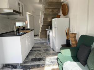 a kitchen and living room with a refrigerator and a couch at Lovers House in Setúbal
