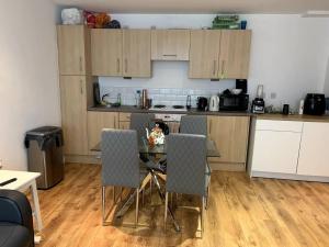 a kitchen with a table and chairs in a room at Large Private Flat in City Centre Leeds in Leeds