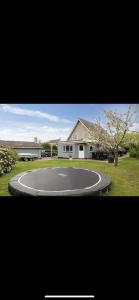 a basketball court in front of a house at Big villa in stege near møns klint with trampolin in Stege