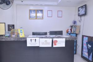 a counter in a room with signs on it at GS Golden Star Hotel in Seri Kembangan