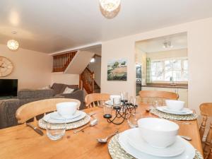 a dining room and living room with a table and chairs at Swallows Nest Cottage in Ambleside