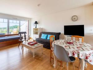 a living room with a table and a couch at Appartement Hendaye, 2 pièces, 4 personnes - FR-1-2-302 in Hendaye