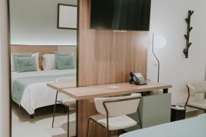 A bed or beds in a room at Catalina Plaza Hotel Sostenible