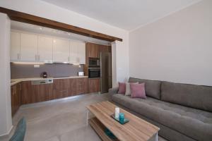 ein Wohnzimmer mit einem Sofa und einem Tisch in der Unterkunft Vigla Apartments No.3 in AmigdhalokeFálion