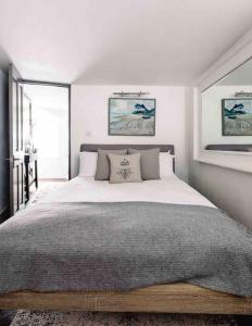 a bedroom with a large bed in a room at The Old Stores, Luxury beach side selfcatered holiday cottage above the beach in Porthleven