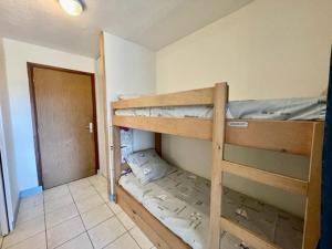 2 Etagenbetten in einem kleinen Zimmer mit einer Tür in der Unterkunft Studio Quiberon, 1 pièce, 4 personnes - FR-1-478-104 in Quiberon