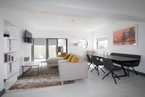 a white living room with a table and a couch at Burrow Holiday Park in Rosslare