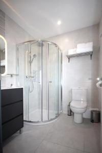 a bathroom with a shower and a toilet at Burrow Park Holiday Apartments in Rosslare