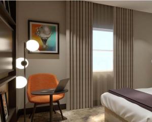 a hotel room with a bed and a laptop on a table at Shannon Springs Hotel in Shannon