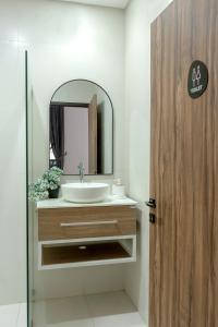 a bathroom with a sink and a mirror at Urbanisia in Betek