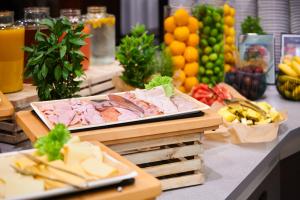 a buffet with meat and cheese and fruits and vegetables at Radisson Blu Szczecin in Szczecin