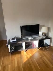 a black entertainment center with a flat screen tv on top at LIA in Lorenskog