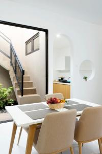 a dining room with a table and chairs and stairs at Urbanisia in Betek