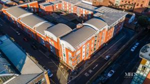 an overhead view of an orange building in a city at Luxury Modern 1 Bedroom Apartment In Birmingham City Centre-Free Parking in Birmingham