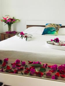 a bed with pink flowers on it with a tray on it at Halikarnas Pansiyon in Bodrum City +73 photos