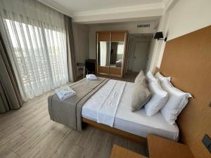 Postel nebo postele na pokoji v ubytování Nova Butik Hotel Çeşme