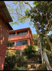 a house with stairs leading up to it at Cabañas cascadas encantadas in Catemaco