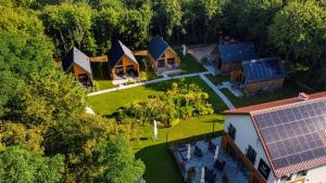 an aerial view of a house with a solar roof at Ośrodek Wypoczynkowy Zapach Drewna Resort & Lake in Barczewo