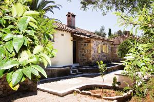 a house with a courtyard in front of it at Drakos Vacation Houses in Stoupa