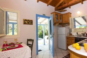 a kitchen with a table and a counter top at Drakos Vacation Houses in Stoupa