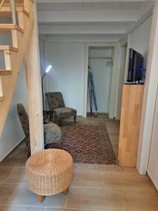 a living room with a staircase and a chair and a rug at Ruhige Art-Garconniere mit Balkon in Vienna