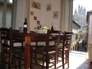 stół jadalny z krzesłami i butelkami wina w obiekcie Il Terrazzino sul Duomo w mieście Orvieto