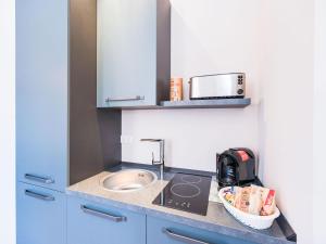 a small kitchen with a sink and a microwave at Charmante Suite für entspannte Tage in Bad Camberg