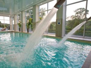 a water fountain in a pool in a building at Kestrel, 19 Dartmouth Green in Totnes