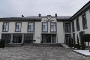 a white building with a sign on the front of it at President Hotel&Restaurant&SPA in Trostyanets