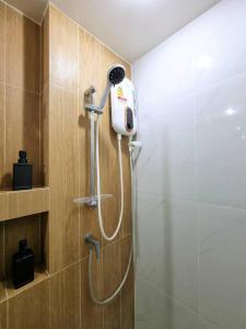 a shower in a bathroom with a shower head at Studio Cozy @Sukumvit50 5mins to Bts Onnut in Bangkok