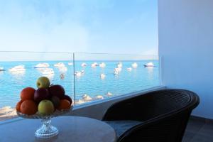a bowl of fruit on a table in front of a window at Shellghada Blue Beach in Hurghada