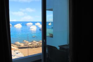 a view of a beach with boats in the water at Shellghada Blue Beach in Hurghada