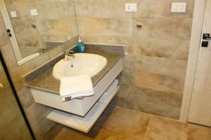 a bathroom with a sink and a mirror at Shellghada Blue Beach in Hurghada