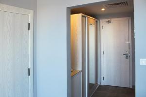 a room with a hallway with a door and a closet at Shellghada Blue Beach in Hurghada