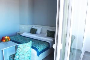 a small bedroom with a bed and a table at Shellghada Blue Beach in Hurghada