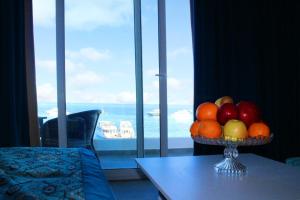 a bowl of fruit on a table in front of a window at Shellghada Blue Beach in Hurghada