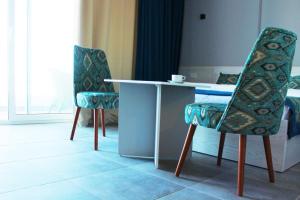 a table and two chairs in a room at Shellghada Blue Beach in Hurghada