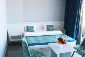 a hotel room with a bed and a table with a bowl of fruit at Shellghada Blue Beach in Hurghada