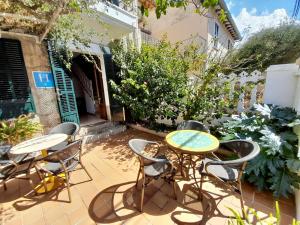 a patio with a table and chairs and plants at Sol Port Soller in Port de Soller
