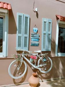 a bike parked next to a building with windows at Bay View in Faliraki