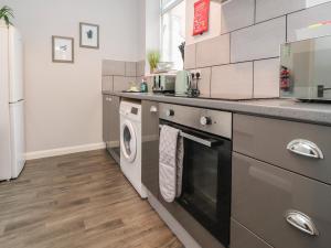 a kitchen with a washer and dryer at Apartment 2 Blackpool Sleepover in Blackpool