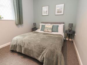a bedroom with a large bed with two tables at Apartment 2 Blackpool Sleepover in Blackpool