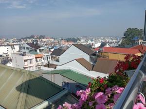 a view of a city with buildings and flowers at Guesthouse Big Lucky in Da Lat +4 photos