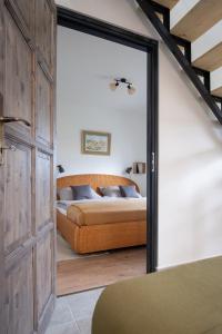 a bedroom with a bed and a large sliding glass door at Stüble Loft in Somogyhárságy