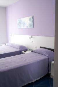 two beds sitting next to each other in a room at Aurea Hotel in Tortoreto Lido