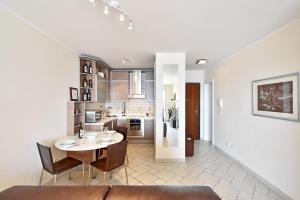 a kitchen and dining room with a table and chairs at Apartment Stiv Luxe in Split