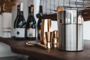 a table with bottles of wine and a juicer at Casa Idalia Boutique Hotel in Comporta