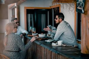 a group of people standing at a bar at Casa Idalia Boutique Hotel in Comporta